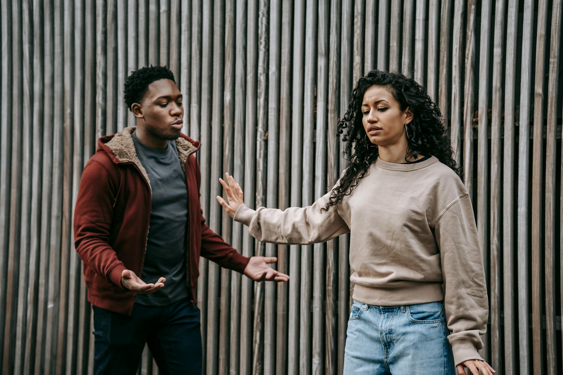 expressive multiethnic couple having conflict on street